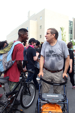 An anti-Black Lives Matter protester yells at demonstrators as they march by.