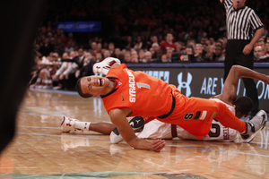 Michael Carter-Williams shouts in pain during a scramble for the ball. The sophomore point guard struggled with 7-of-15 free-throw shooting.