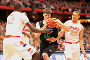 Syracuse center Baye Moussa Keita and shooting guard Brandon Triche swarm Notre Dame's Jack Cooley in the paint. The forward finished with 10 points and 11 rebounds.