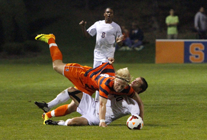 Emil Ekblom falls over Patrick Foss. The Virginia midfielder grabbed the Syracuse forward's jersey as the two tumbled to the ground.