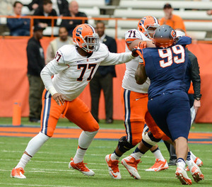 Kendall Moore (77) played mostly tight end last year but lined up at center on Saturday and delivered thebiggest block of thegame.