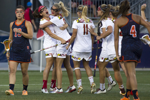 Syracuse players watch as Maryland celebrates during its win over the Orange. SU's season ended with a loss against UMD for the third straight year. 