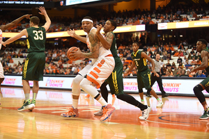 DaJuan Coleman holds the ball up against a Le Moyne player as he looks to advance toward the basket.