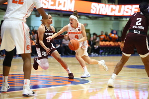 Tiana Mangakahia drives to the basket against Chennedy Carter. The SU guard had 26 points in the win.