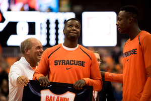 Antonio Balandi holds up his jersey at SU's senior night celebration.