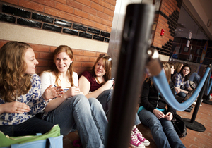 Students sit along the wall outside Goldstein Auditorium in Schine Student Center on Wednesday, waiting to see 'Saturday Night Live' comedian Andy Samberg speak. The lne began forming six hours before the doors opened and wrapped outside around the building.