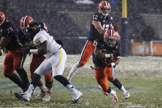 Prince-Tyson Gulley takes a carry into the WVU defense in the first half.