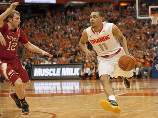 Ennis drives toward the paint while N.C. State point guard Tyler Lewis tries to obstruct his path. 