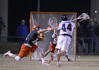 Virginia forward Chris LaPierre fires a shot toward Syracuse goalie Dominic Lamolinara. 