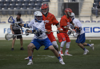 Jordan Wolf is guarded by Brandon Mullins of Syracuse.