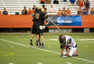 Matt Harris stares down at the Carrier Dome turf, his Syracuse career over, while Bryant players celebrate their upset of the No. 2-seeded Orange.