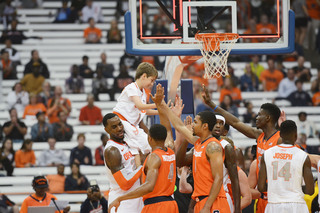 Christmas lifts up Nick Trivelpiece, a 10-year old who has connected with the SU basketball team through a program that joins children with brain tumors with high school and college athletes. Trivelpiece entered the game at the end of the scrimmage and made a layup. 