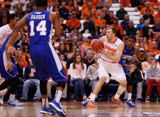 Cooney moves to his right and closer to the lane as he scans the floor for an open teammate. 