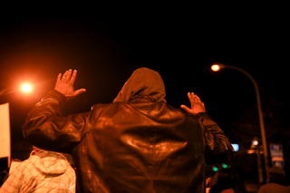 A marcher holds up his arms as protesters chanted 