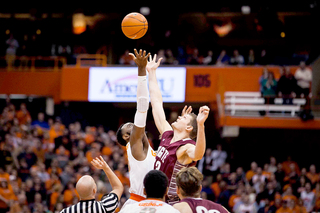 Christmas goes up for the opening tip against Colgate center Ethan Jacobs.