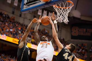 Roberson scraps with Mitoglou and another Demon Deacon underneath the basket.