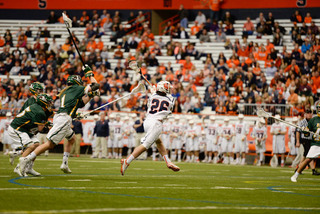 J.T. Forkin runs through the Saints' restraining box as three defenders trail behind him.