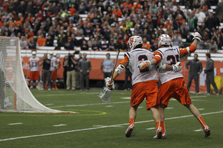 SU midfielder Paolo Ciferri and Rice celebrate Ciferri's second goal of the season en route to the Orange's 13-10 victory.