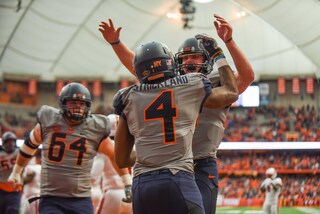 Strickland celebrates with Mahoney as Byrne also looks to join the mob.