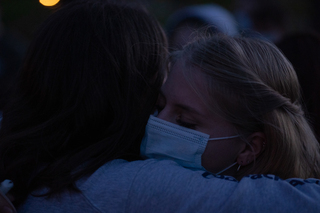 Two attendees hug after the vigil.